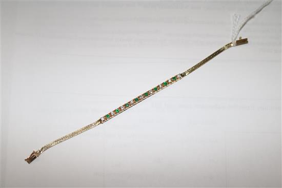 A 14ct gold, emerald and diamond small line bracelet, 15cm.